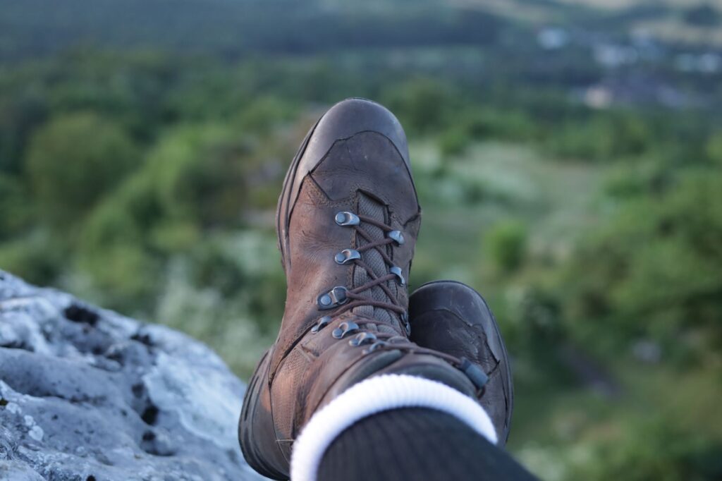 man wearing brown shoes on a hill